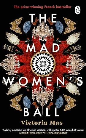 Book cover for 'The Mad Women's Ball' by Victoria Mas, featuring ornate, symmetrical decorative elements and a central black-and-white circular pattern, with the title prominently displayed.