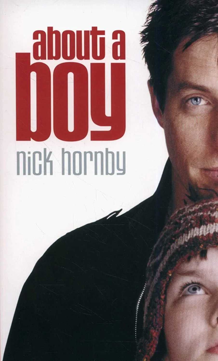 Book cover for 'About a Boy' by Nick Hornby, featuring part of a man's face with blue eyes and a young boy wearing a colorful knit hat.