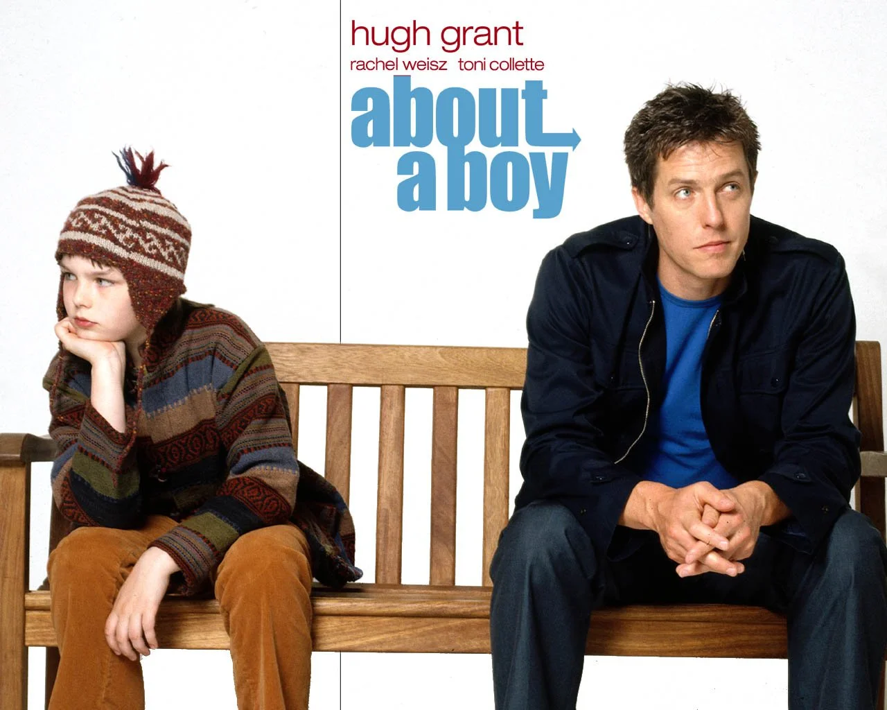 Poster for the movie 'About a Boy' featuring Hugh Grant and a young boy sitting on a bench, with Hugh Grant looking away and the boy resting his head on his hand.