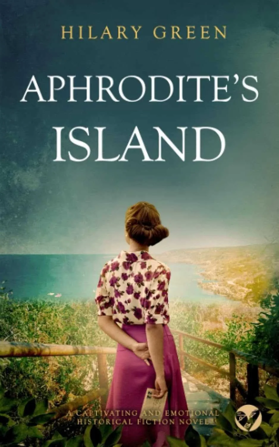 Book cover of 'Aphrodite's Island' by Hilary Green, showing a woman in a vintage dress holding a book, standing on a path overlooking a coastal landscape with greenery, water, and a sky with clouds.