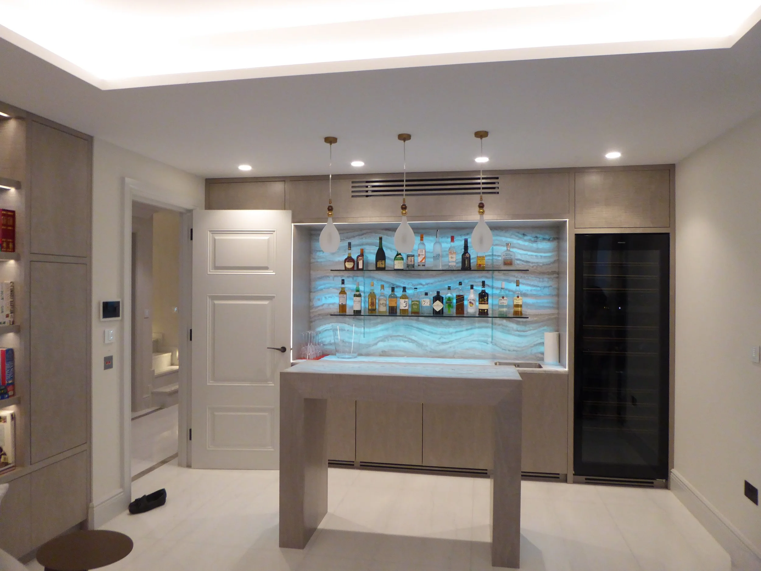 Basement bar area with backlit onyx stone