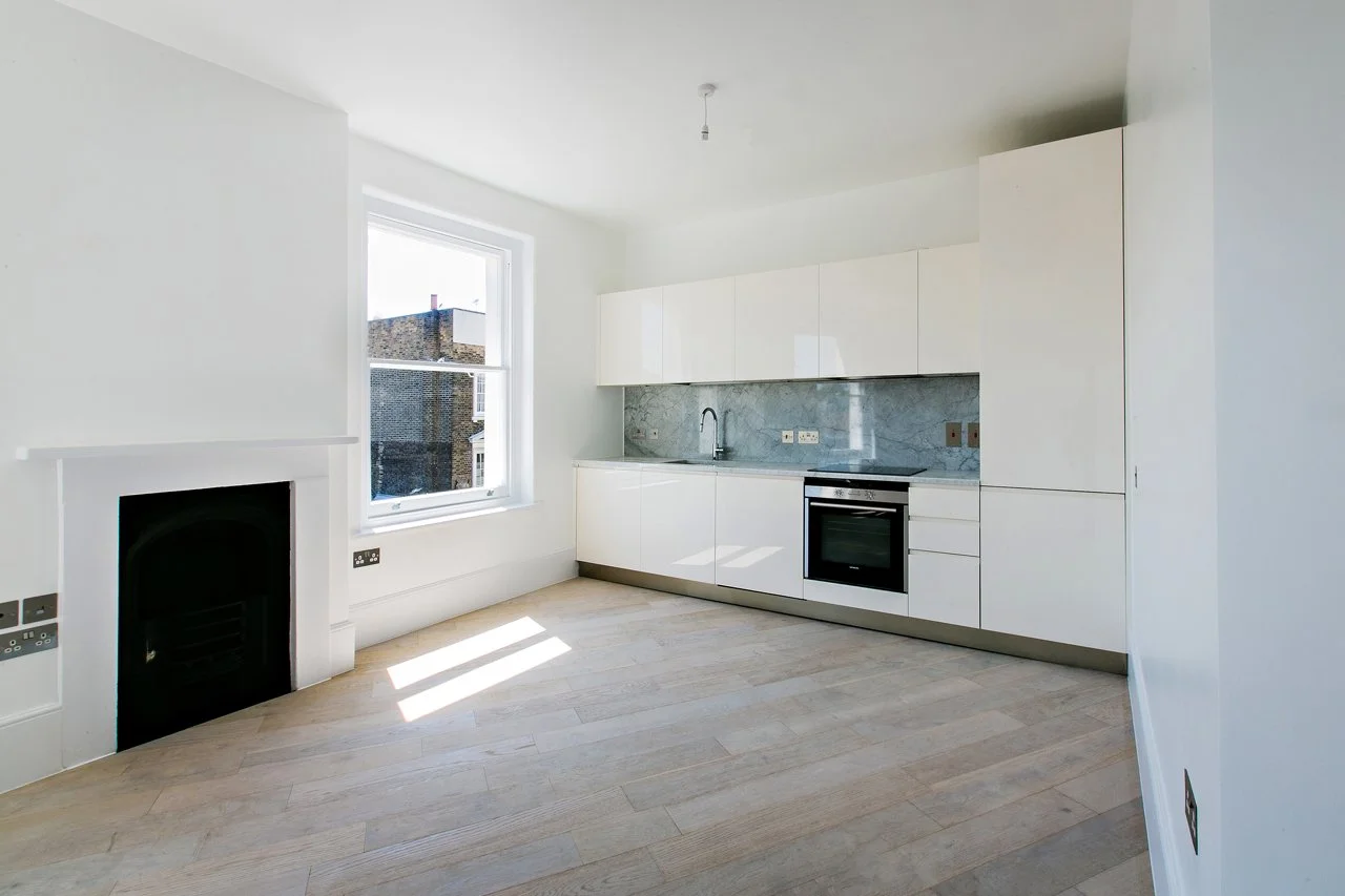New open plan Kitchen and retained fireplace.