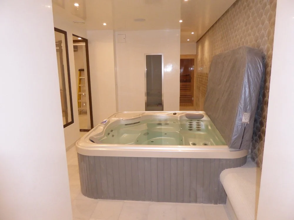Hot tub with steam room and sauna beyond