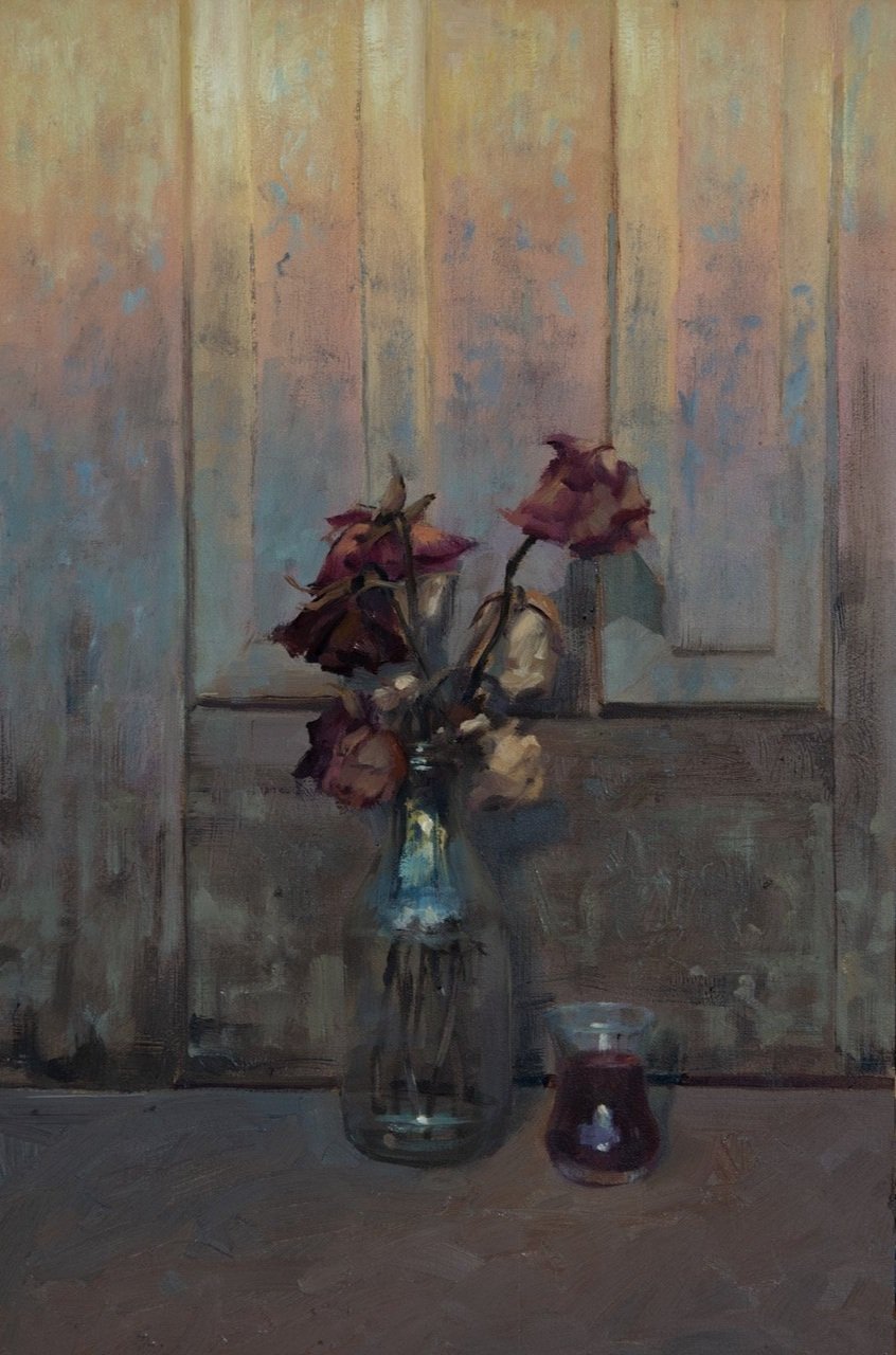 A still life painting of wilted roses in a glass vase and a small jar of dark red liquid on a wooden surface against a textured, painted wooden panel background.