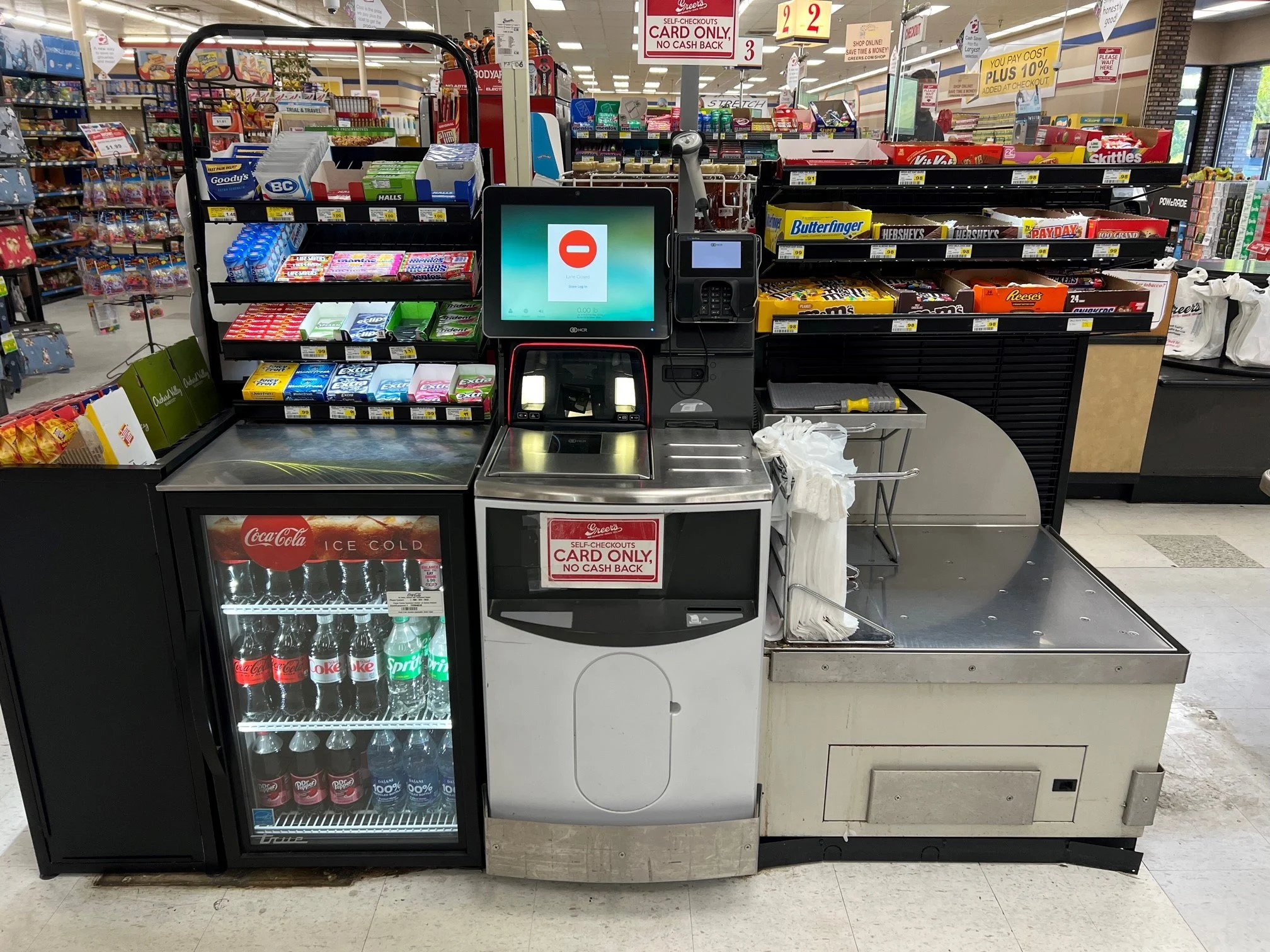 A grocery store aisle with a sign that says 'The Kitchen' and various snack items on display.