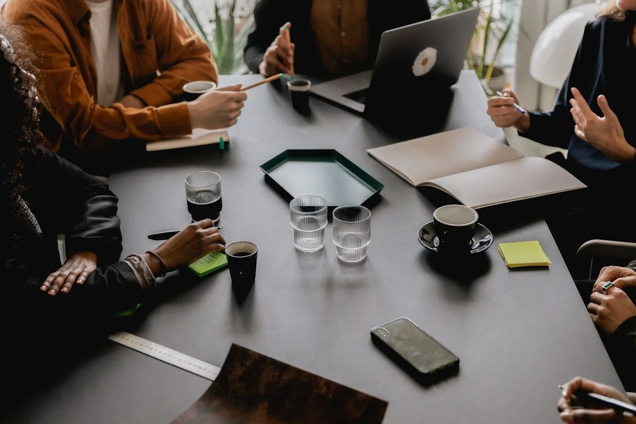 High angle shot of a group of business people having a creative meeting showing their drinking glasses and coffee cups.
