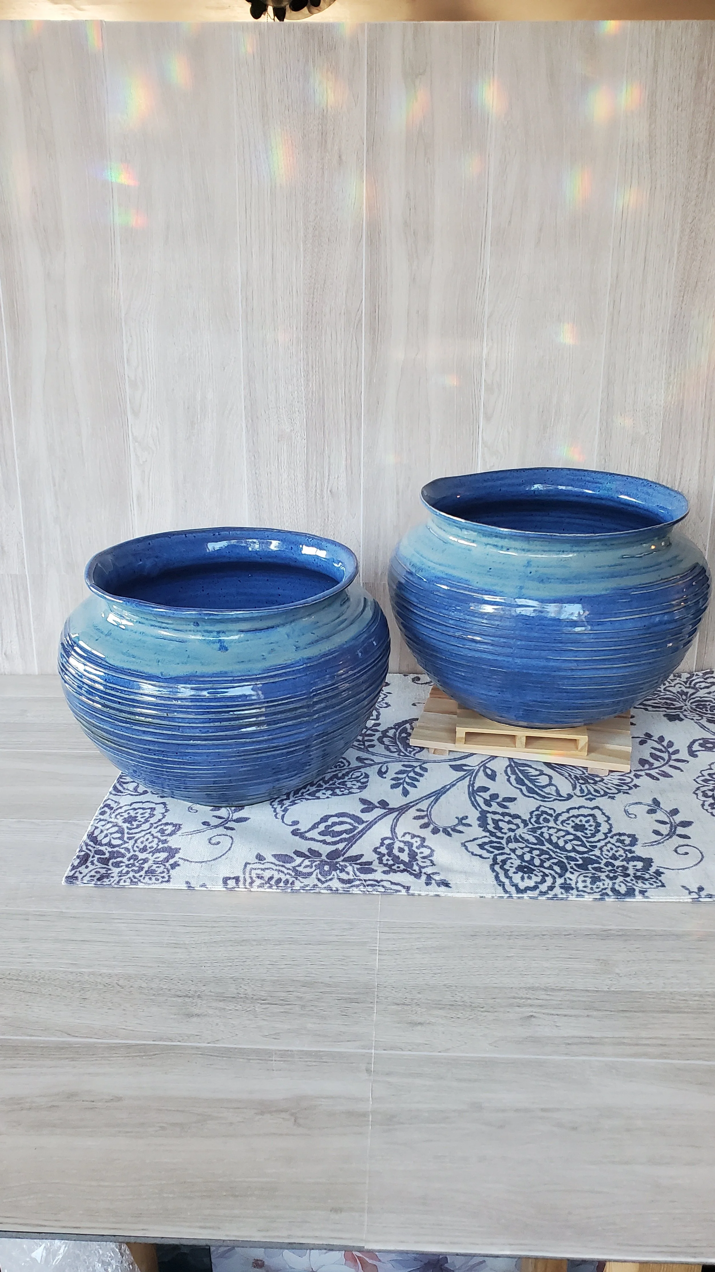 Two large ceramic blue planters.