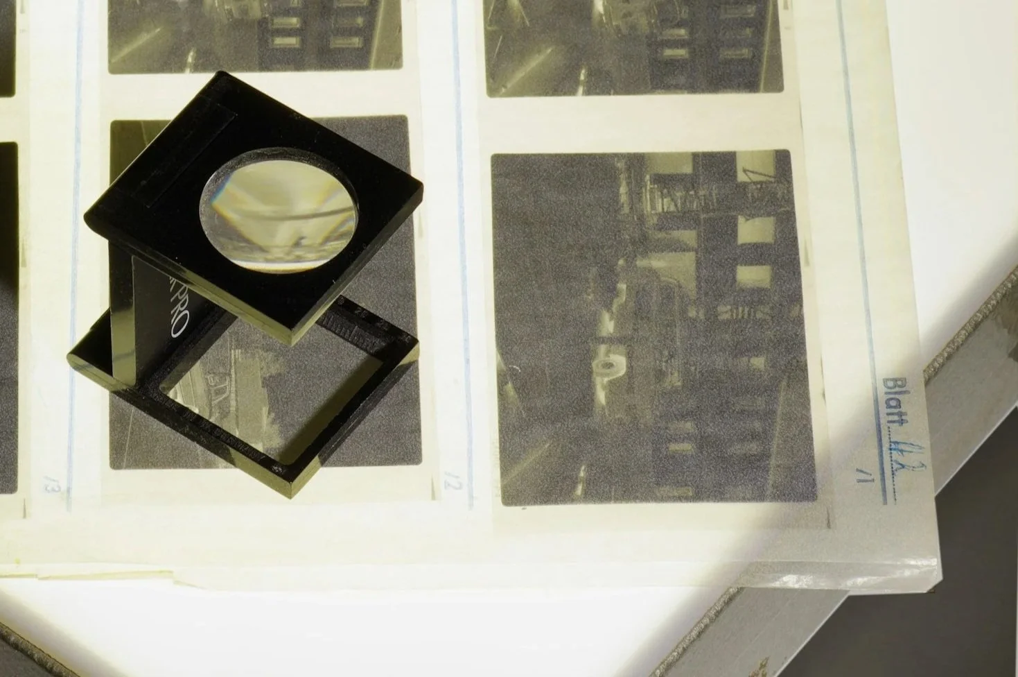 anologue photographers use a loupe to view negatives up close