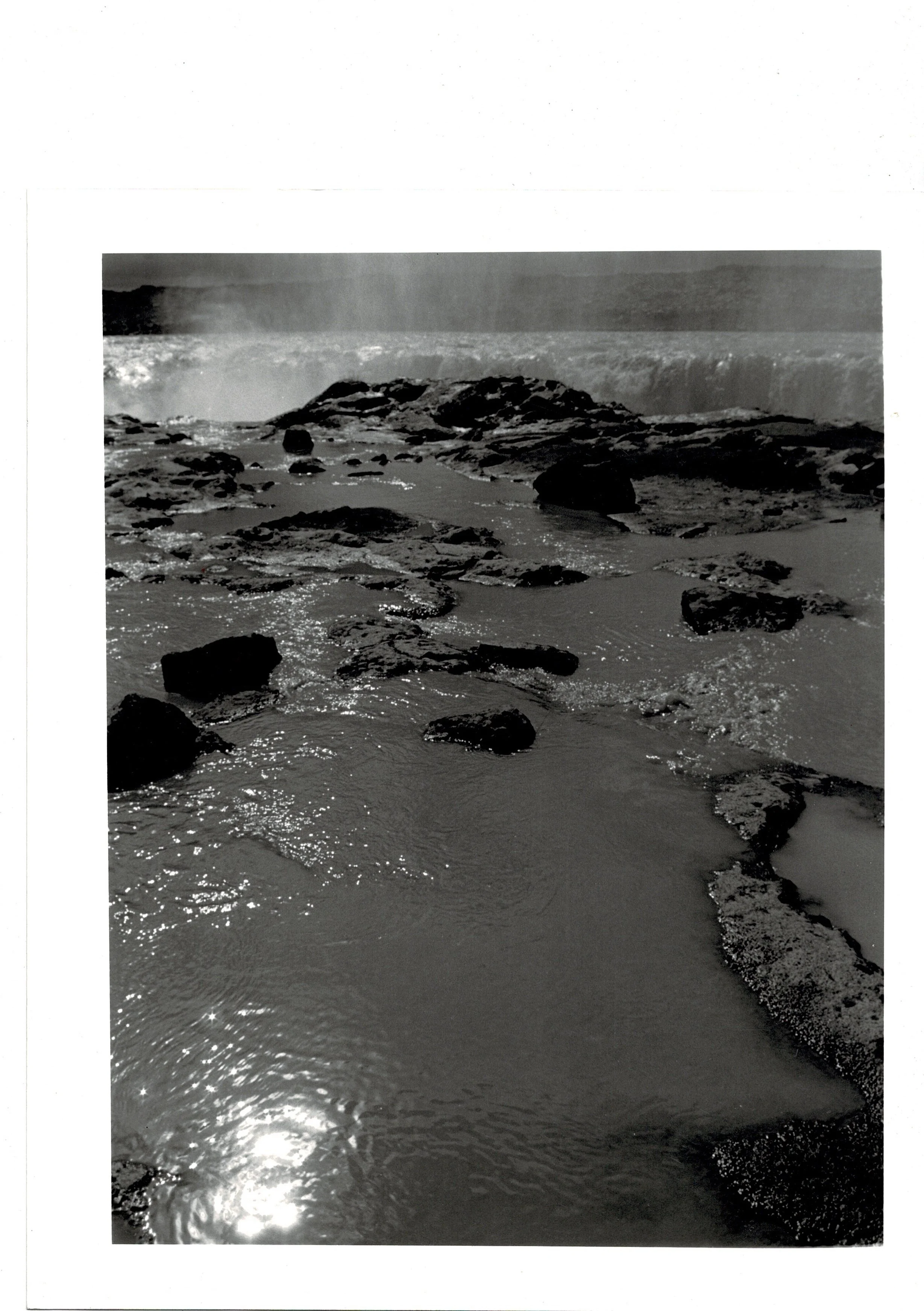 Handprinted, darkroom print of rocks and water by analogue photographer ,Tony Hockley