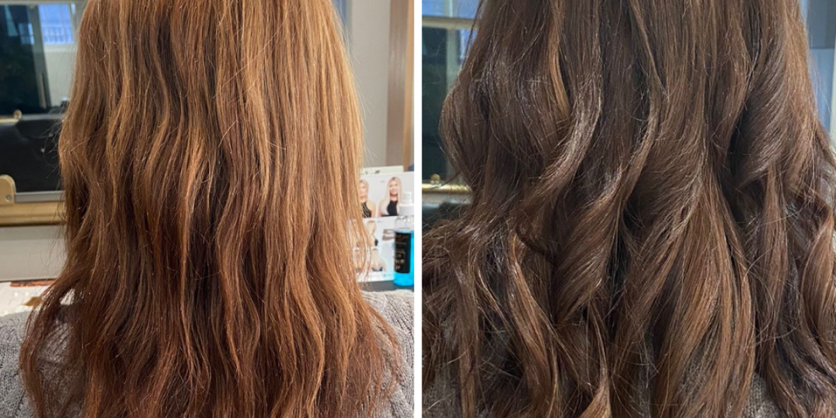 Person with long, straight, blonde hair, wearing a navy-blue shirt, in a salon setting.