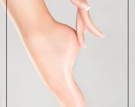 Close-up of a hand gently pinching the skin on a person's thigh.