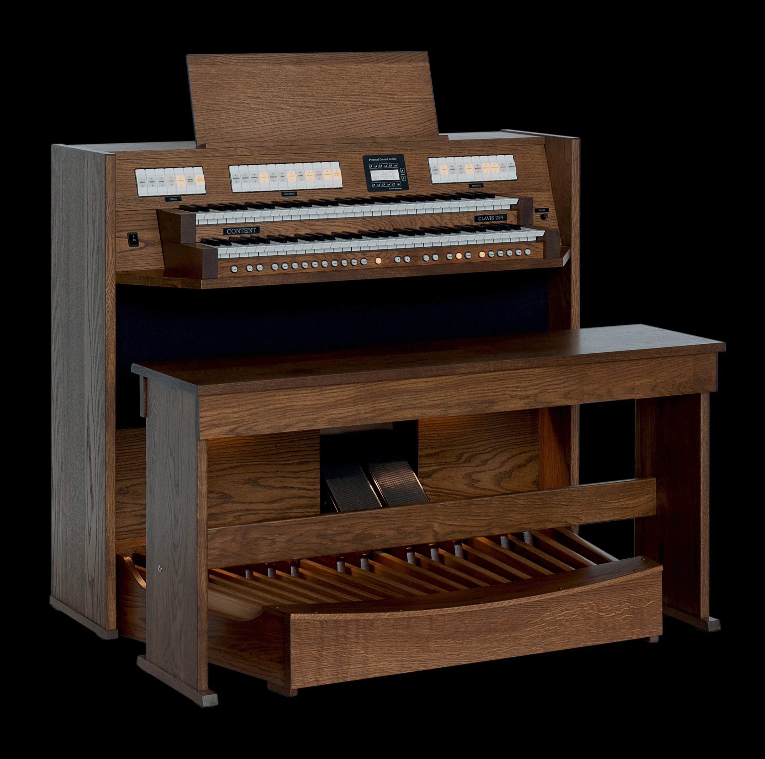 A vintage wooden church pipe organ with multiple manuals, stop tabs, and a pedalboard against a black background.