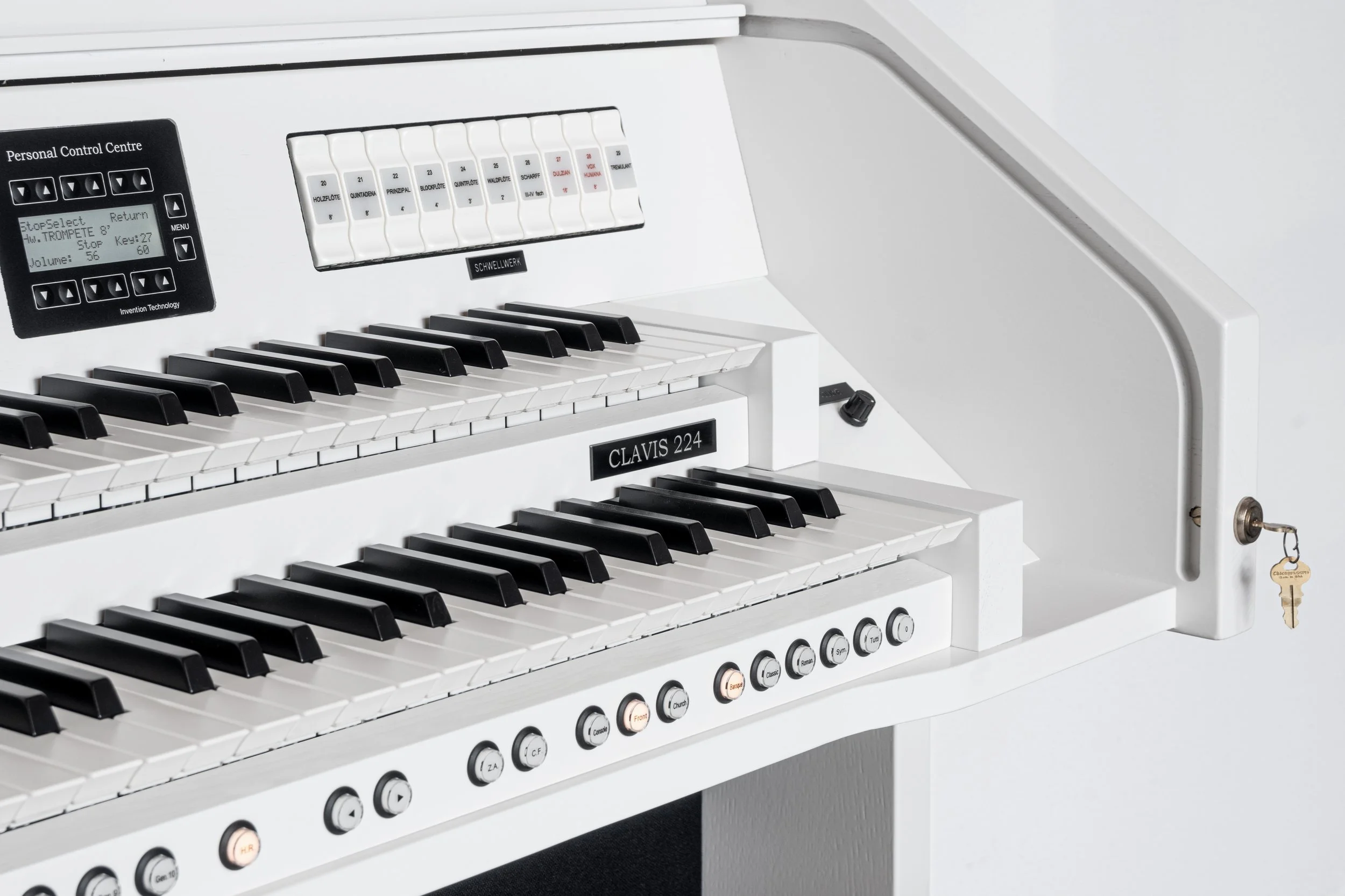 White electronic organ with black and white keys, labeled CLAVIS 224, with control buttons and switches, and a key in a lock on the right side.