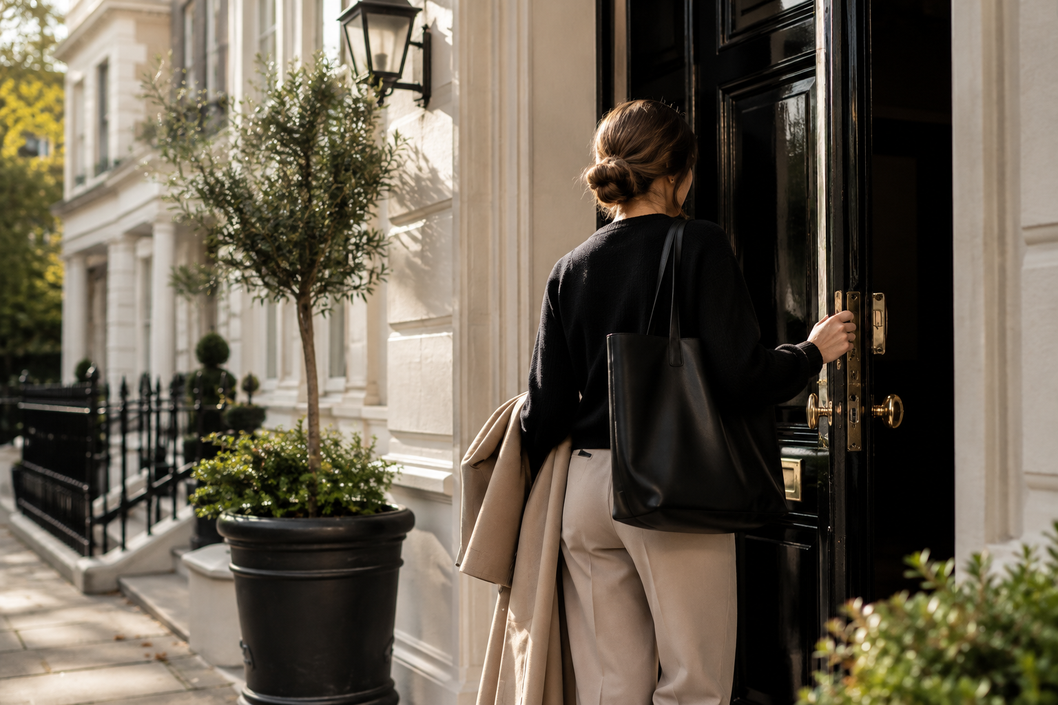 Woman leaving a private household carrying a work bag, representing the importance of maintaining healthy boundaries when working in a private home.