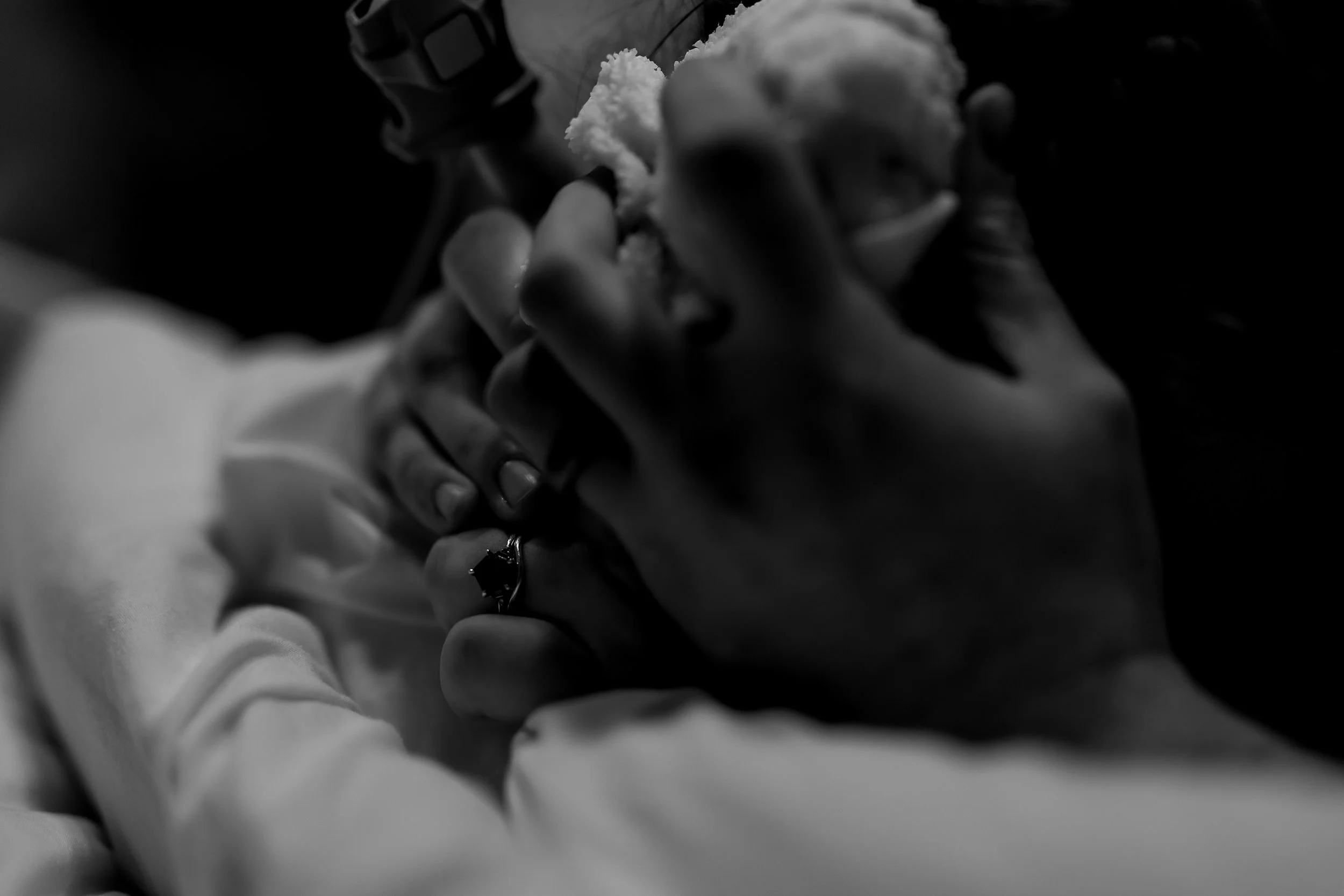 Hands clasped in support during a labor contraction.