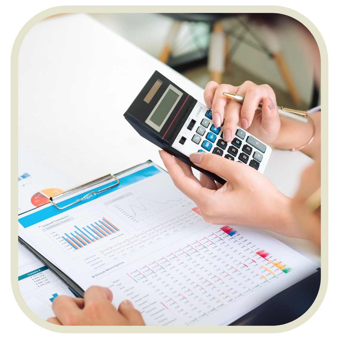 People analyzing financial data with charts and a calculator on a desk.