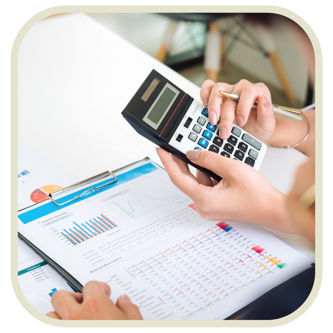 Person using calculator and pen to review financial charts and graphs on paper.