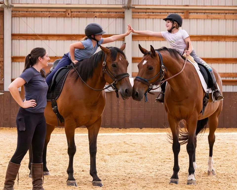 Children on horseback high five one another as an adult looks on