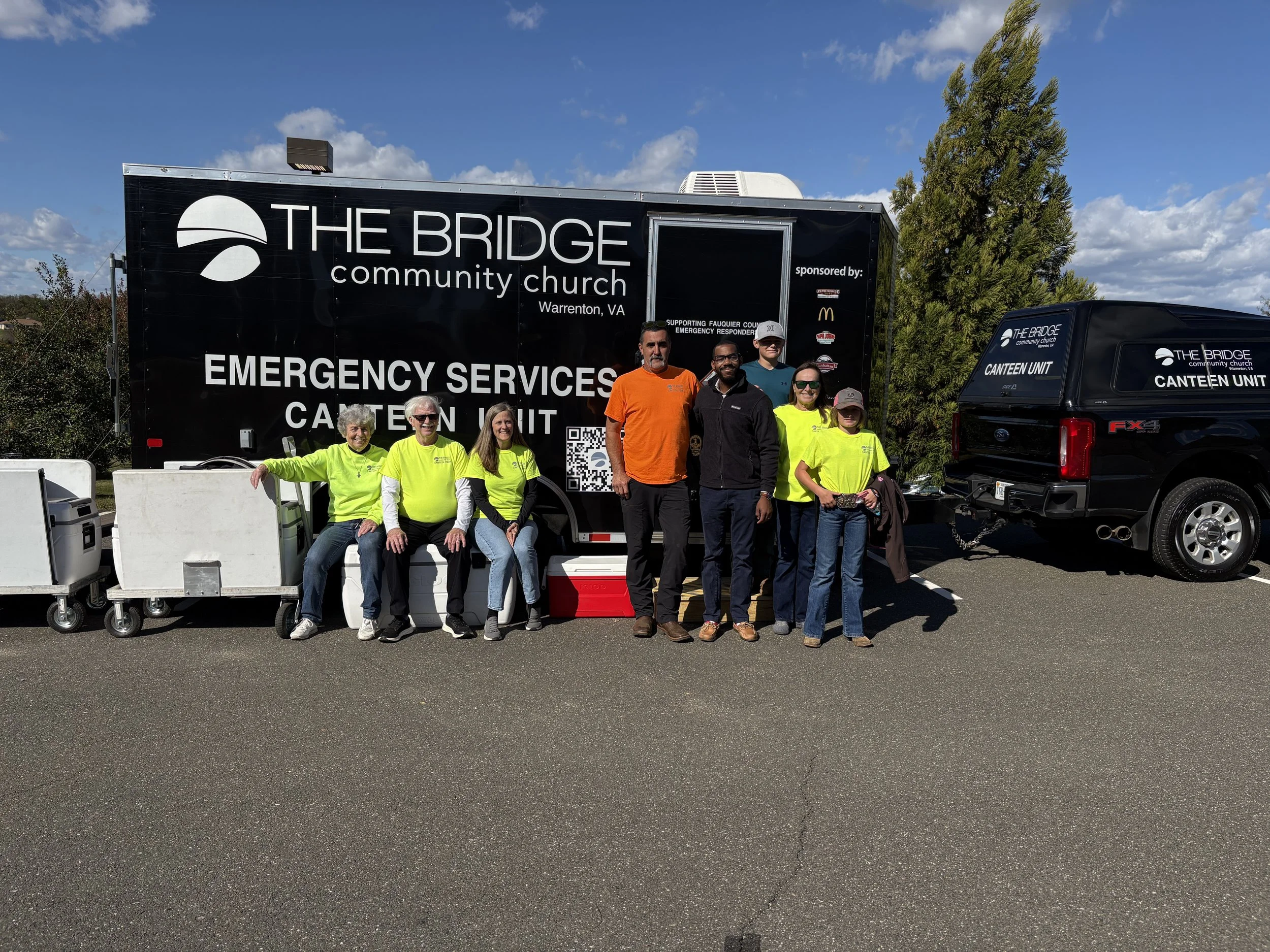 A group stands in front of a trailer
