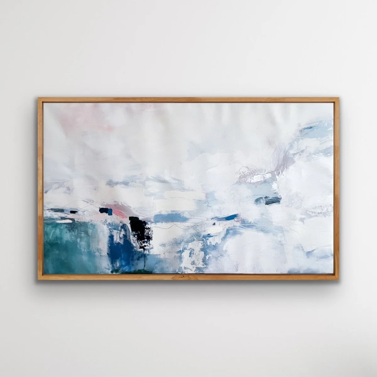 Abstract painting with shades of white, blue, gray, and black, framed in wood, hung on a white wall.