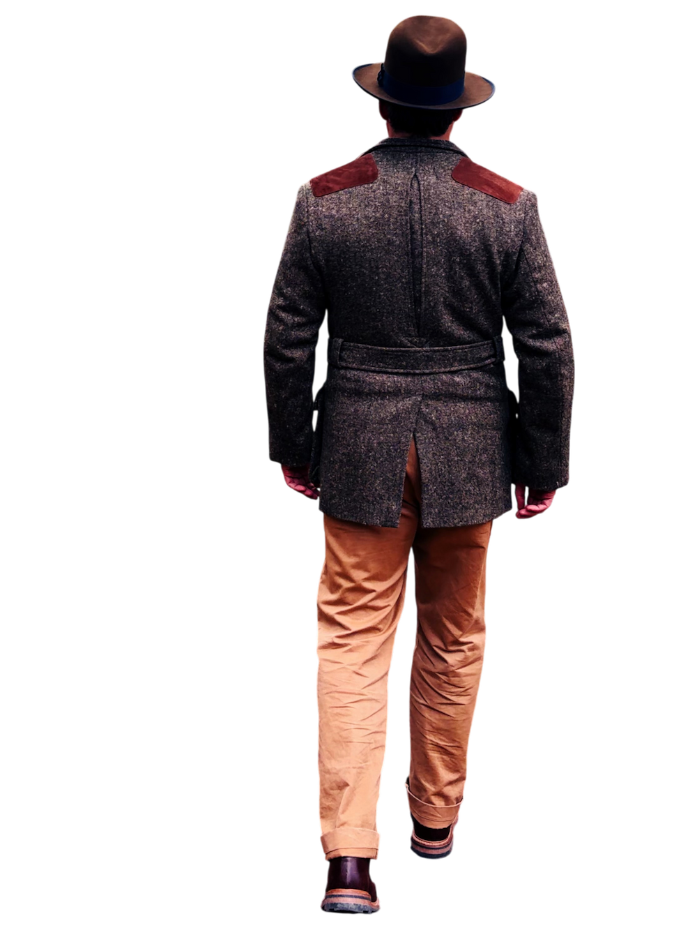 D walking away dressed in a tweed jacket with shoulder patches, tan pants, dark shoes, and wearing a wide-brimmed hat.