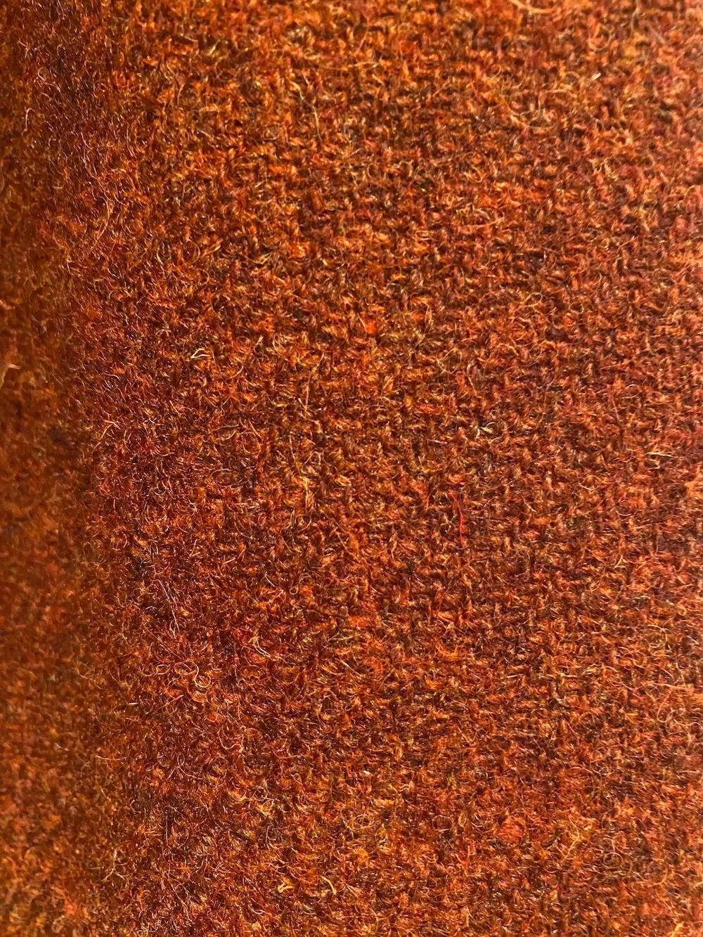Close-up of a textured orange tweed.