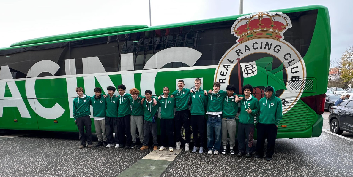 Group of young men in green tracksuits standing in front of a large bus with the Celtic Football Club logo.