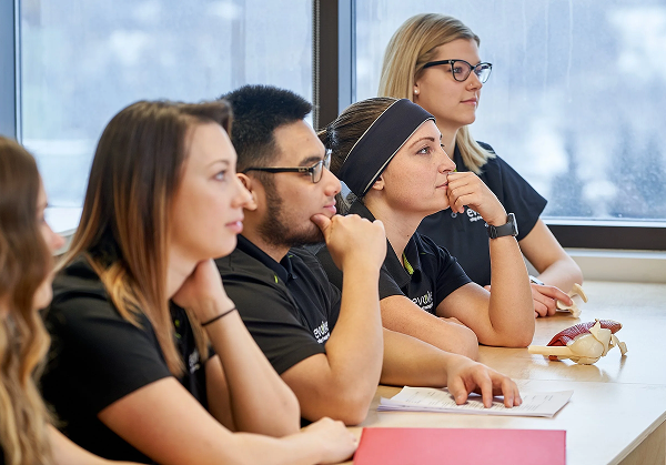 Image with massage therapy students listening in a Evolve College classroom