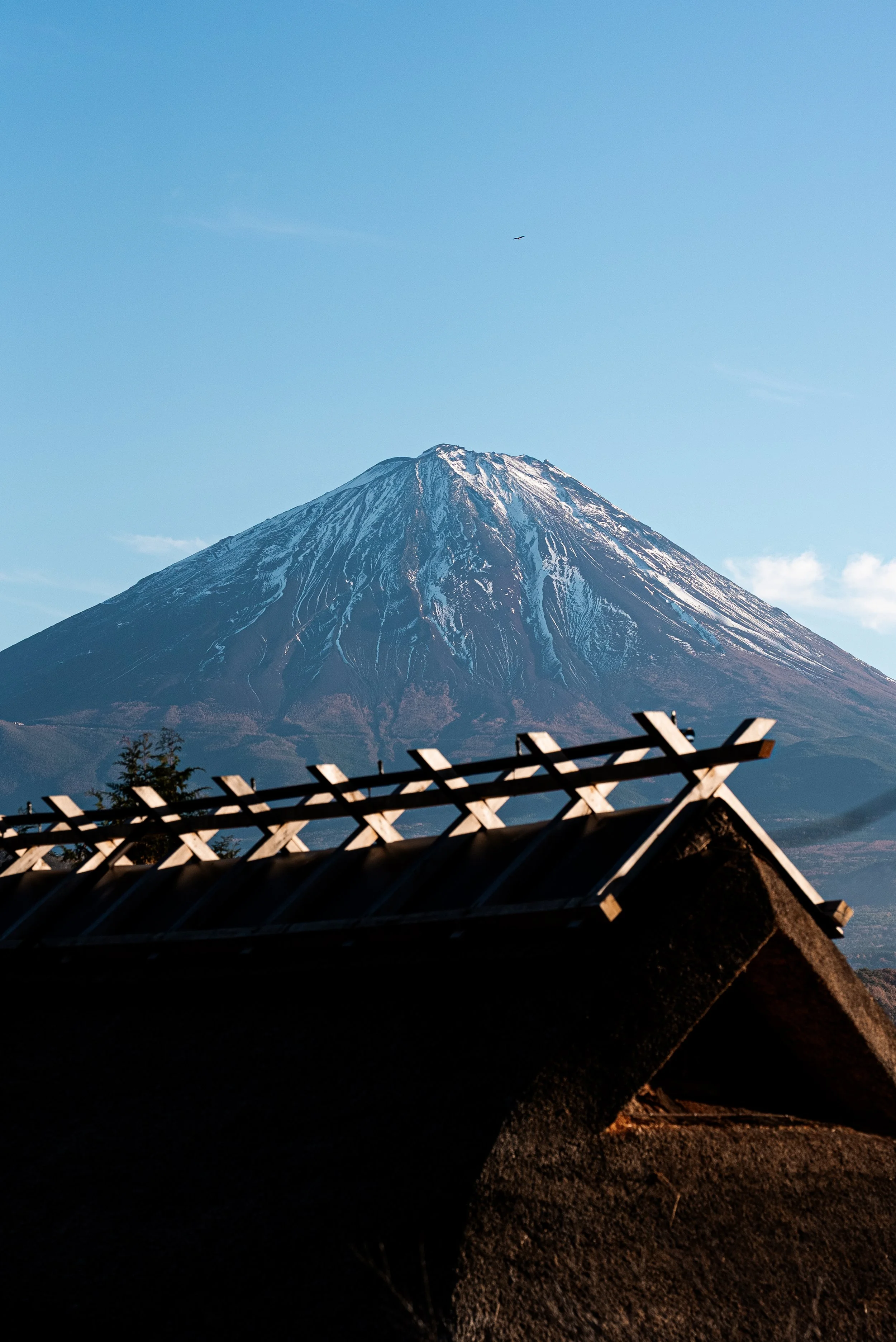 Montagne avec sommet enneigé vue depuis une structure de toit en début de soirée ou matinée.