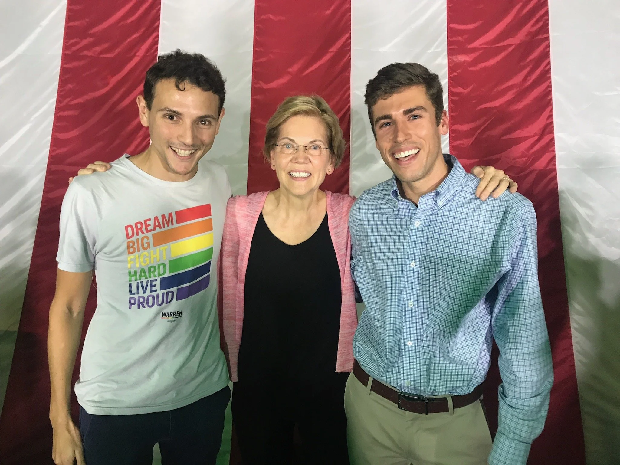 Daniel and his husband stand with Elizabeth Warren