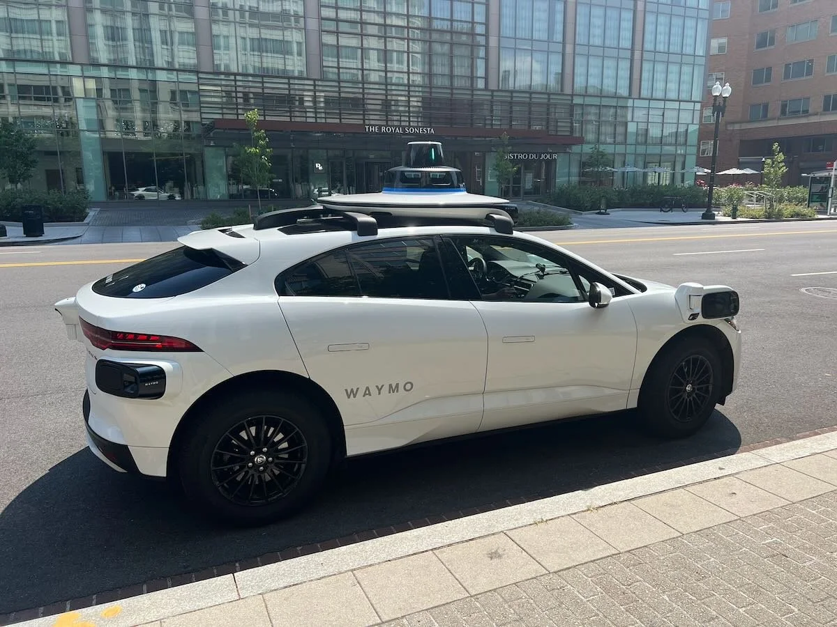 Waymo Jaguar I-PACE parked by a curb in Washington, DC.