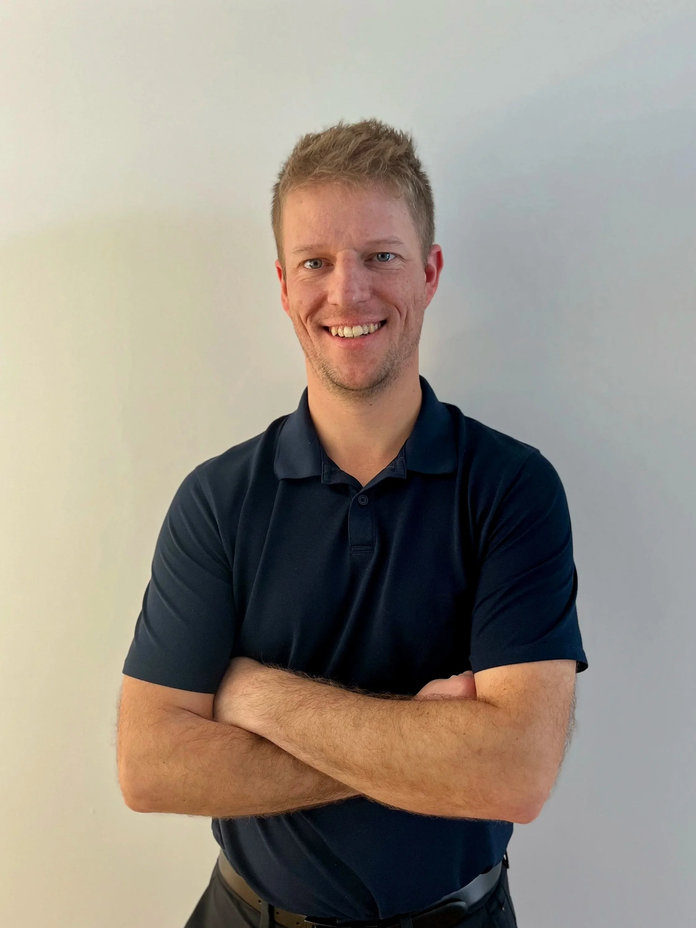 Dr Josh Smiling with arms crossed pose