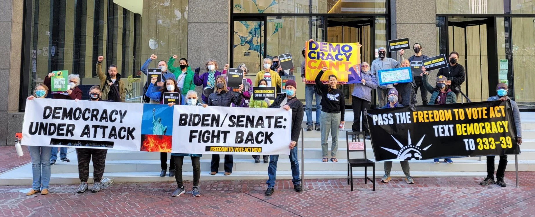 Demonstrators hold banners at the No Vacation Without Representation Protes