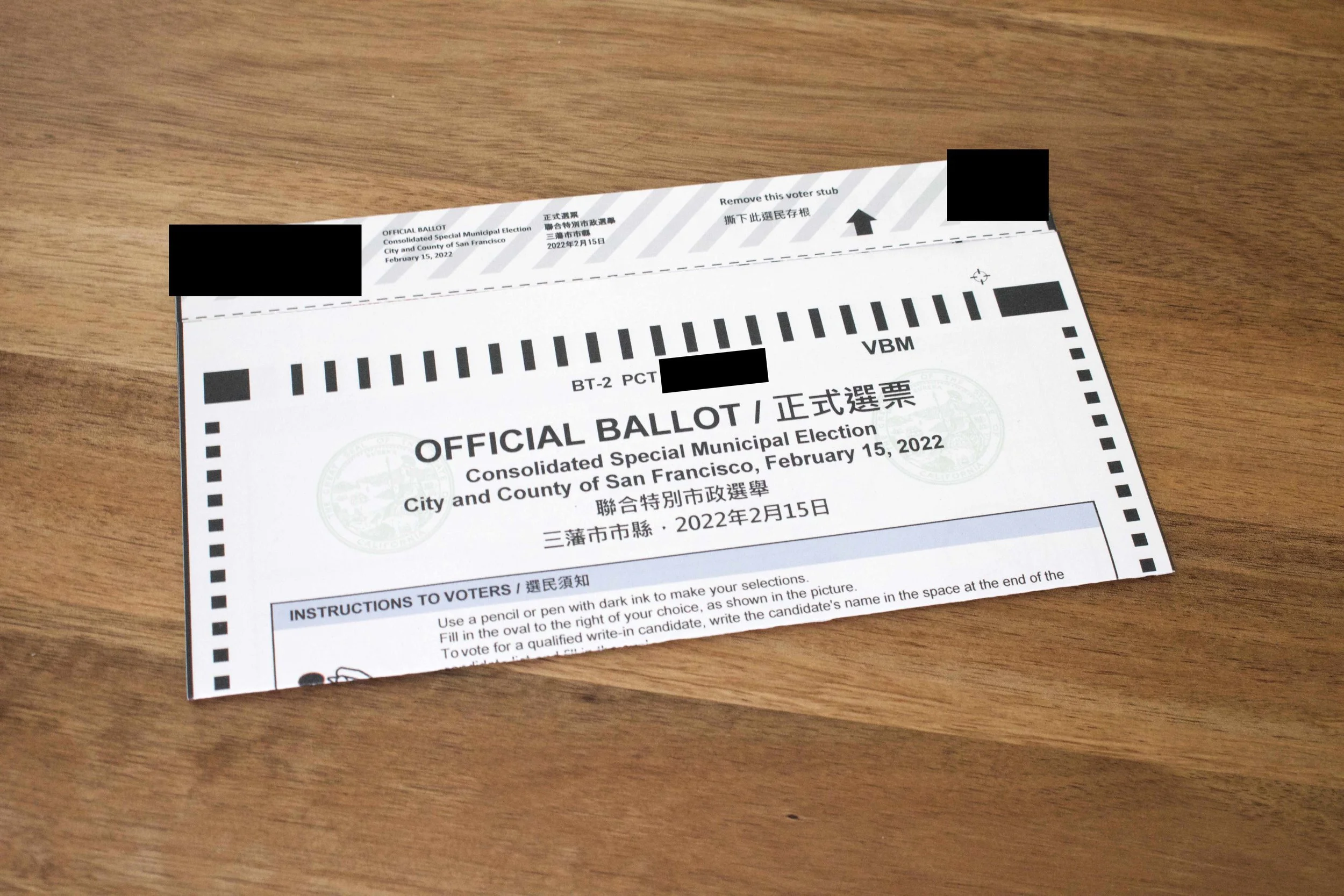 Photo of the ballot card, with its stub still attached at the top, sitting on a desk.