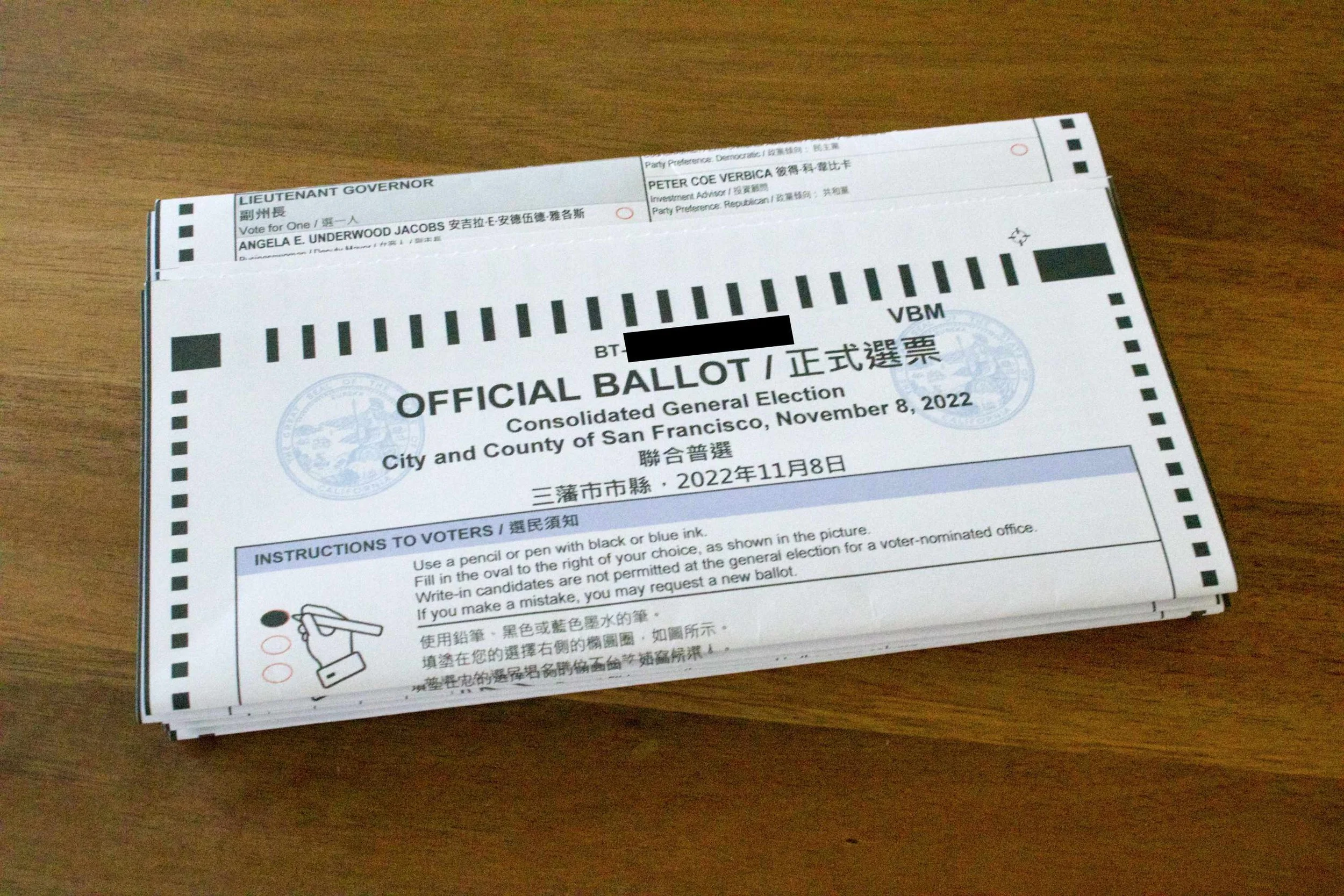 A stack of ballot cards ready for mailing. Each card is folded alone before being added to the stack, so the cards can be removed from the stack by elections workers without having to un-nest them.