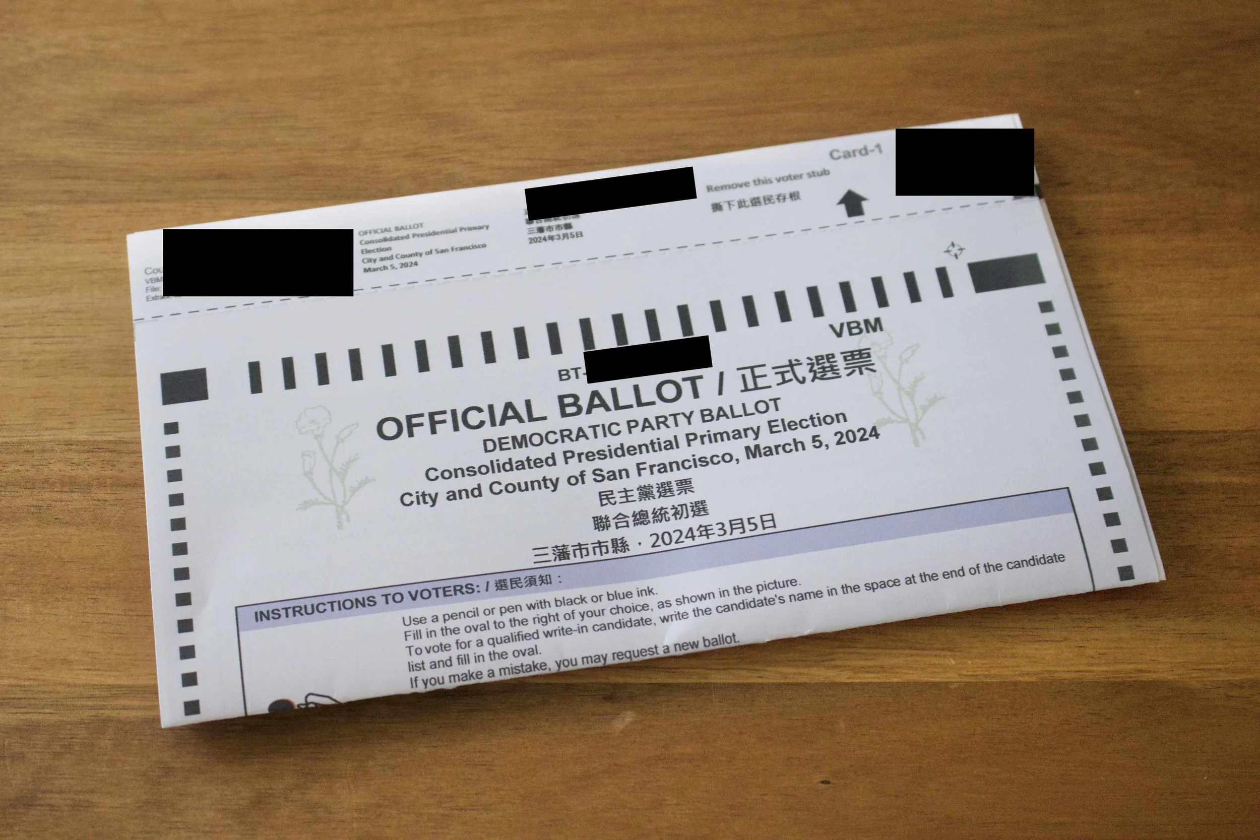 Ballot cards in a nested stack, with their stubs still attached..