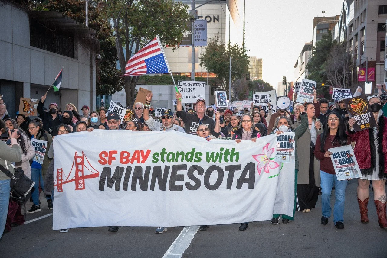 Protesters with a large banner that reads “SF Bay stands with Minnesota”