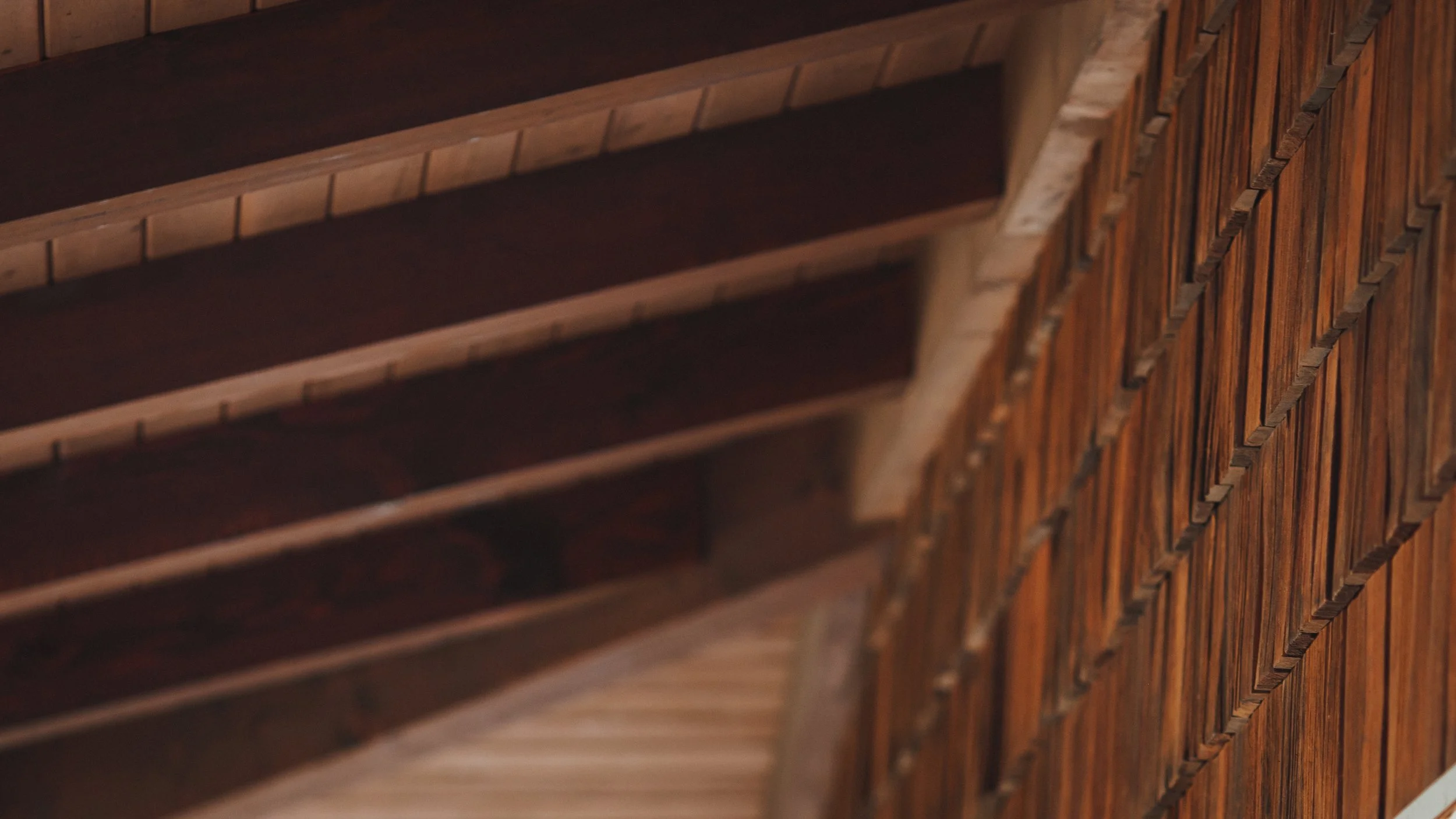 Close-up of dark wooden shelves and a lattice-style wooden room divider, showing the wood grain and construction details.