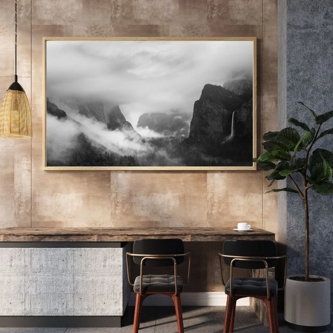 Frame mockup in a living room setting of a black and white photograph of Yosemite Valley