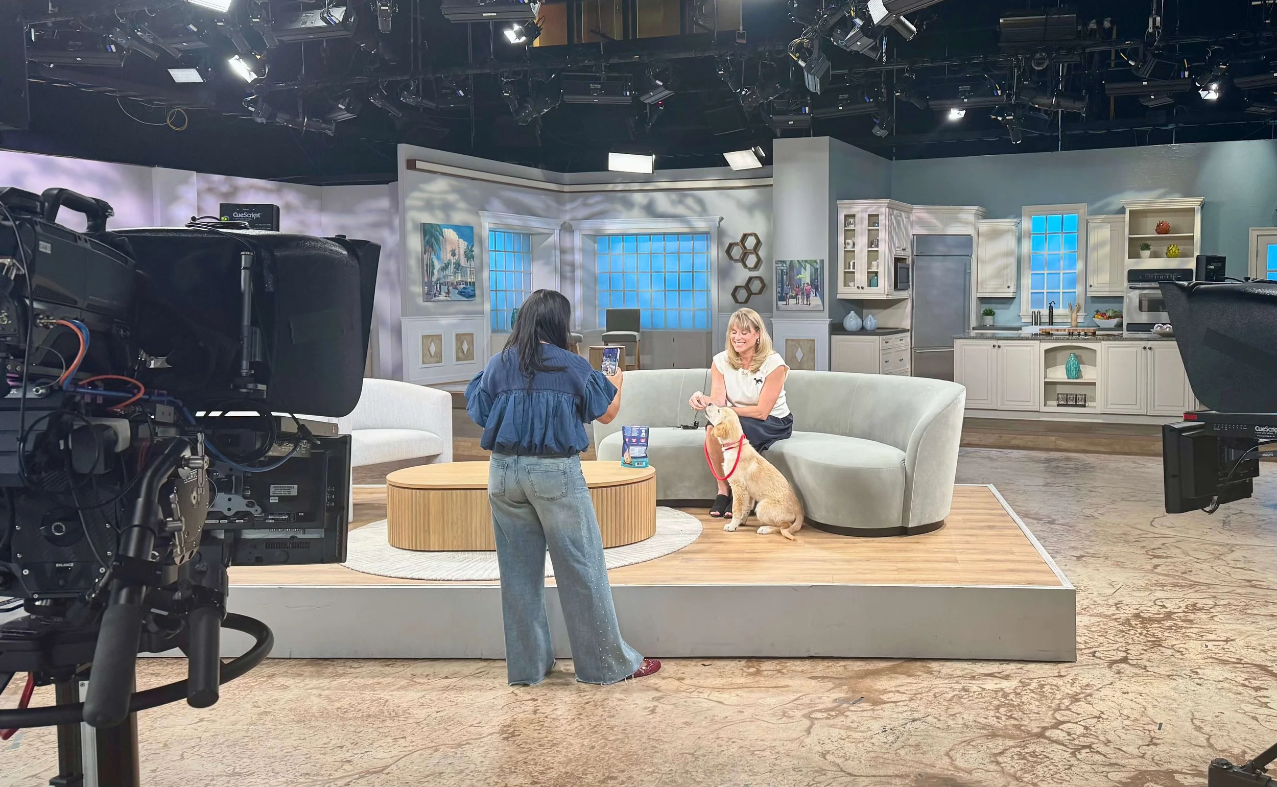 Kelly on set with a dog for Kellys Pet Picks By Paws PR TV
