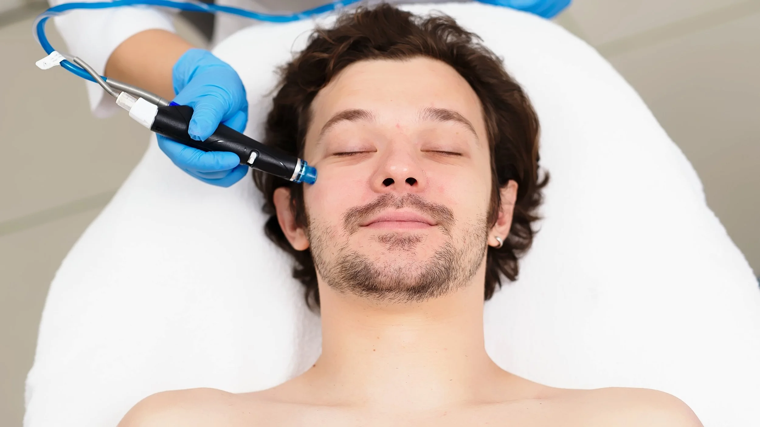 Man relaxing getting a hydrofacial