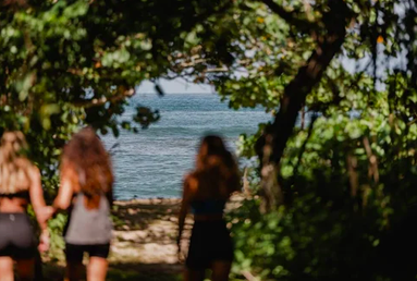 women walking to beach on a yoga retreat in costa rica
