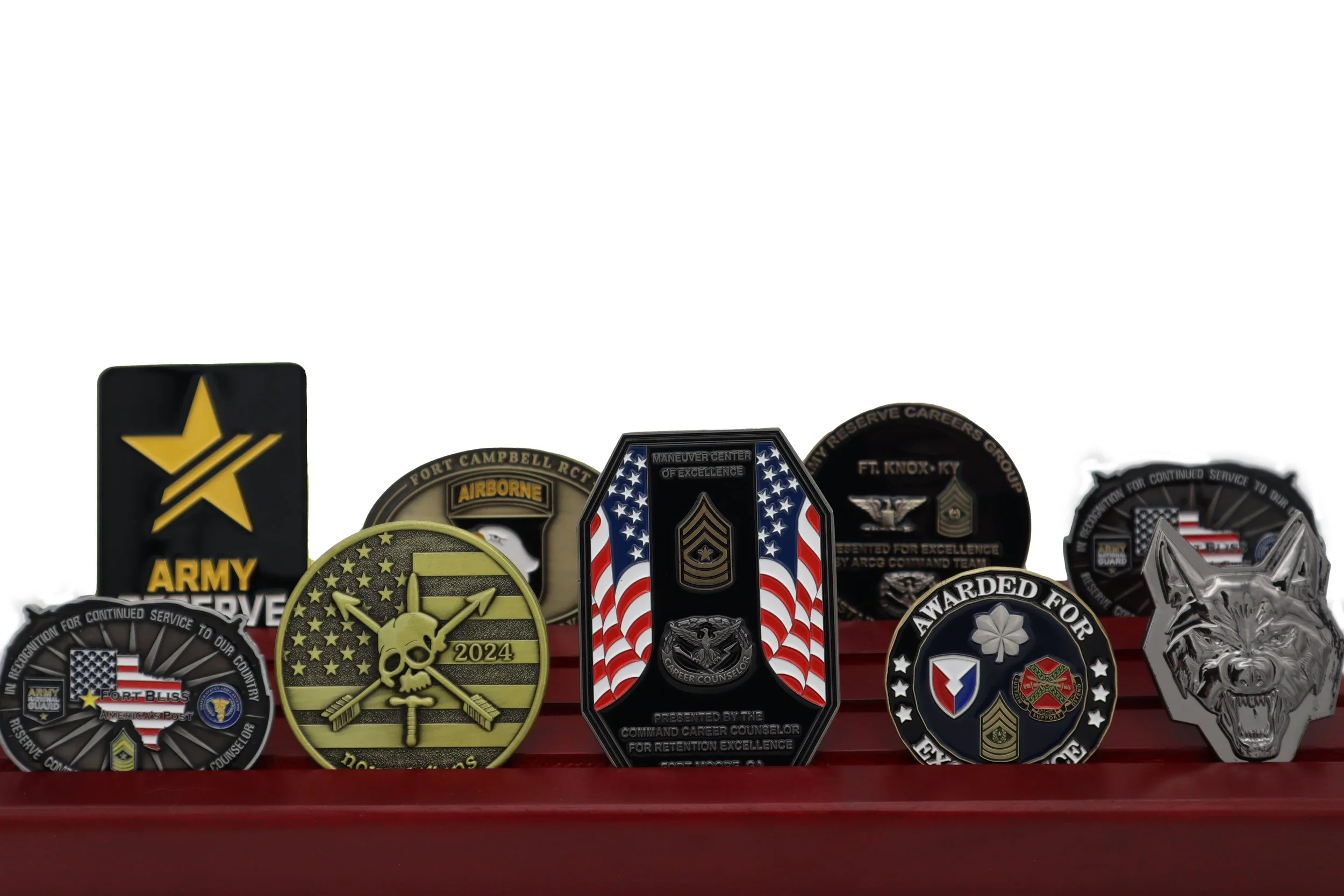 A collection of various military and service medals, some with badges and ribbons, displayed on a red surface.