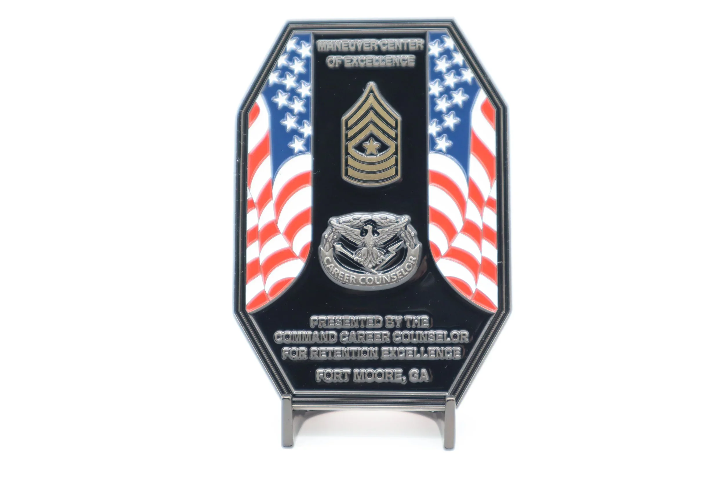A military-style badge with red, white, and blue patriotic colors announcing an award from the Command Career Counselor for retention excellence, presented in Fort Moore, Georgia.