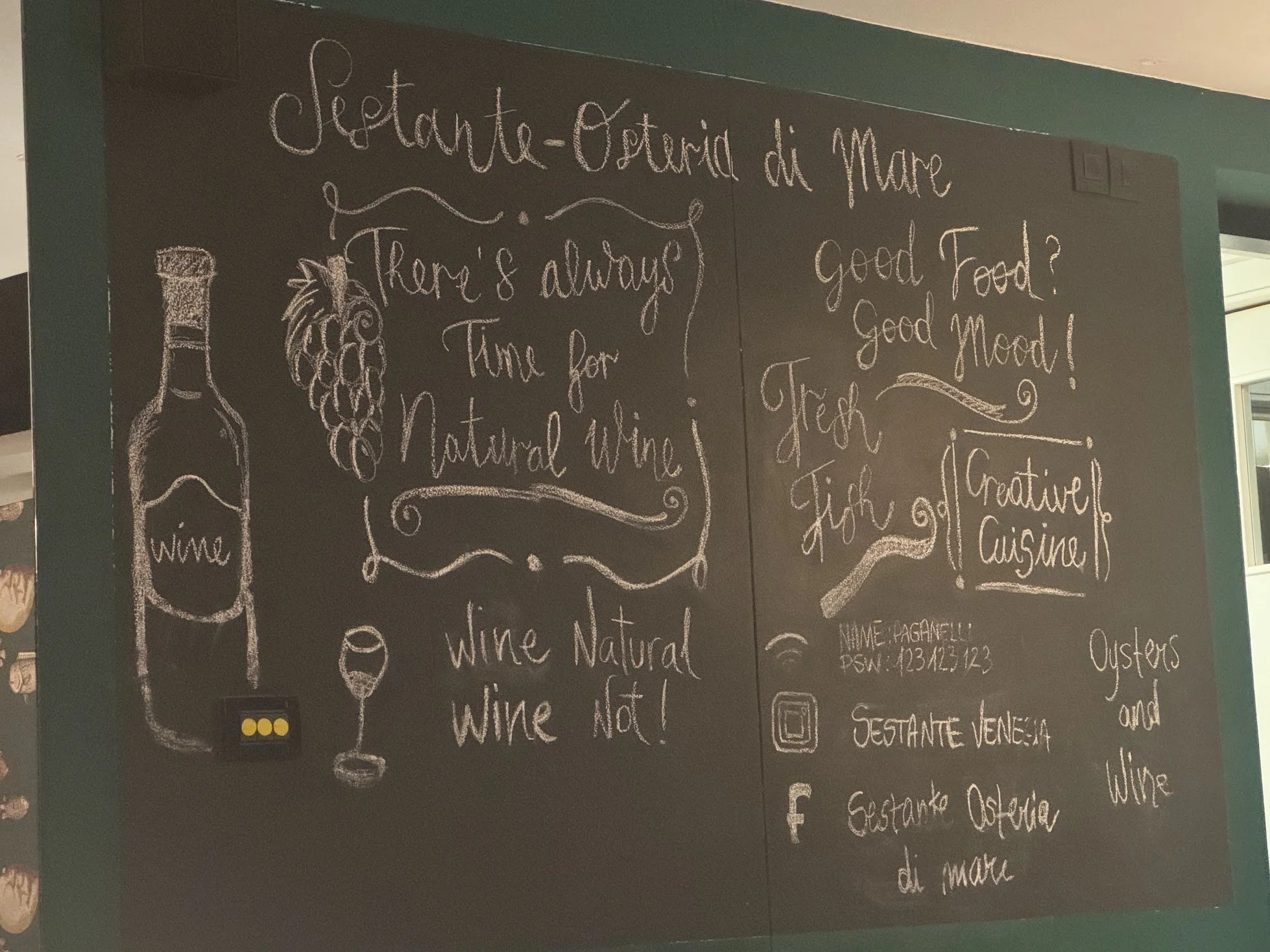 Chalkboard with handwritten text and illustrations about the Mediterranean diet, including wine, grapes, and wine bottles. The text mentions seafood, wine, and fresh ingredients, with some words like 'wine', 'Natural', and 'not'.