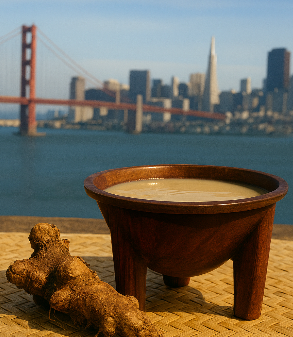 A bowl of soy milk on a woven mat with a piece of ginger root nearby, with the San Francisco skyline and Golden Gate Bridge in the background.