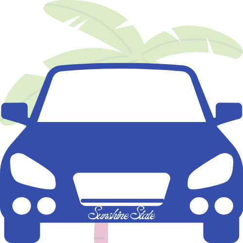 Front view of a blue car with a banana plant in the background.