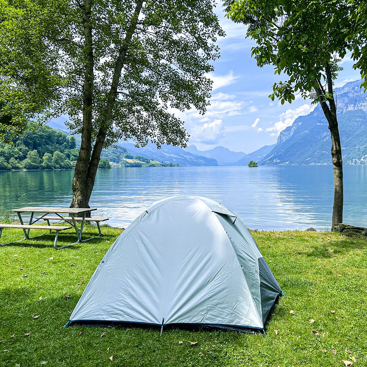 Gray tent near a large lake.