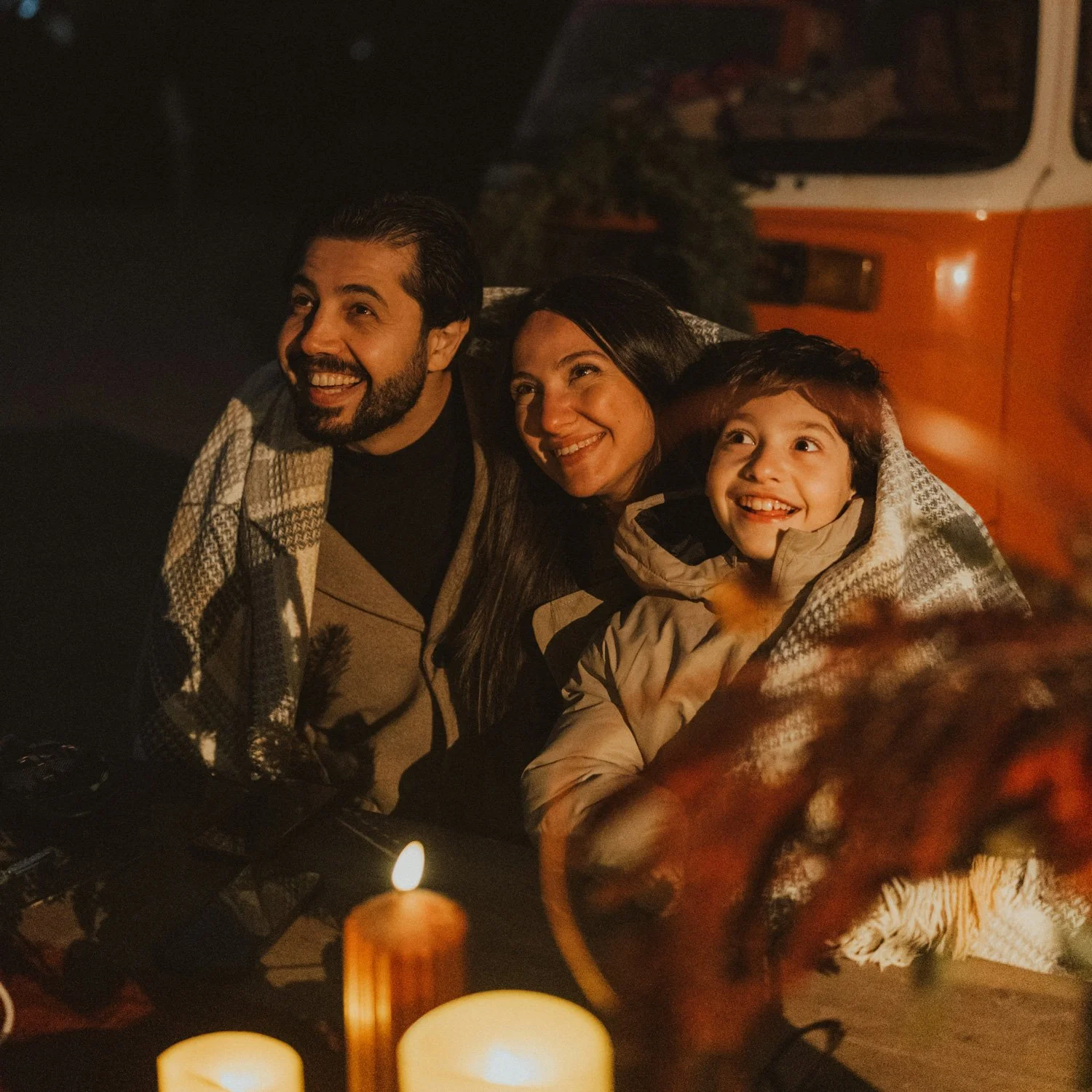 Family shares fun time by campfire.