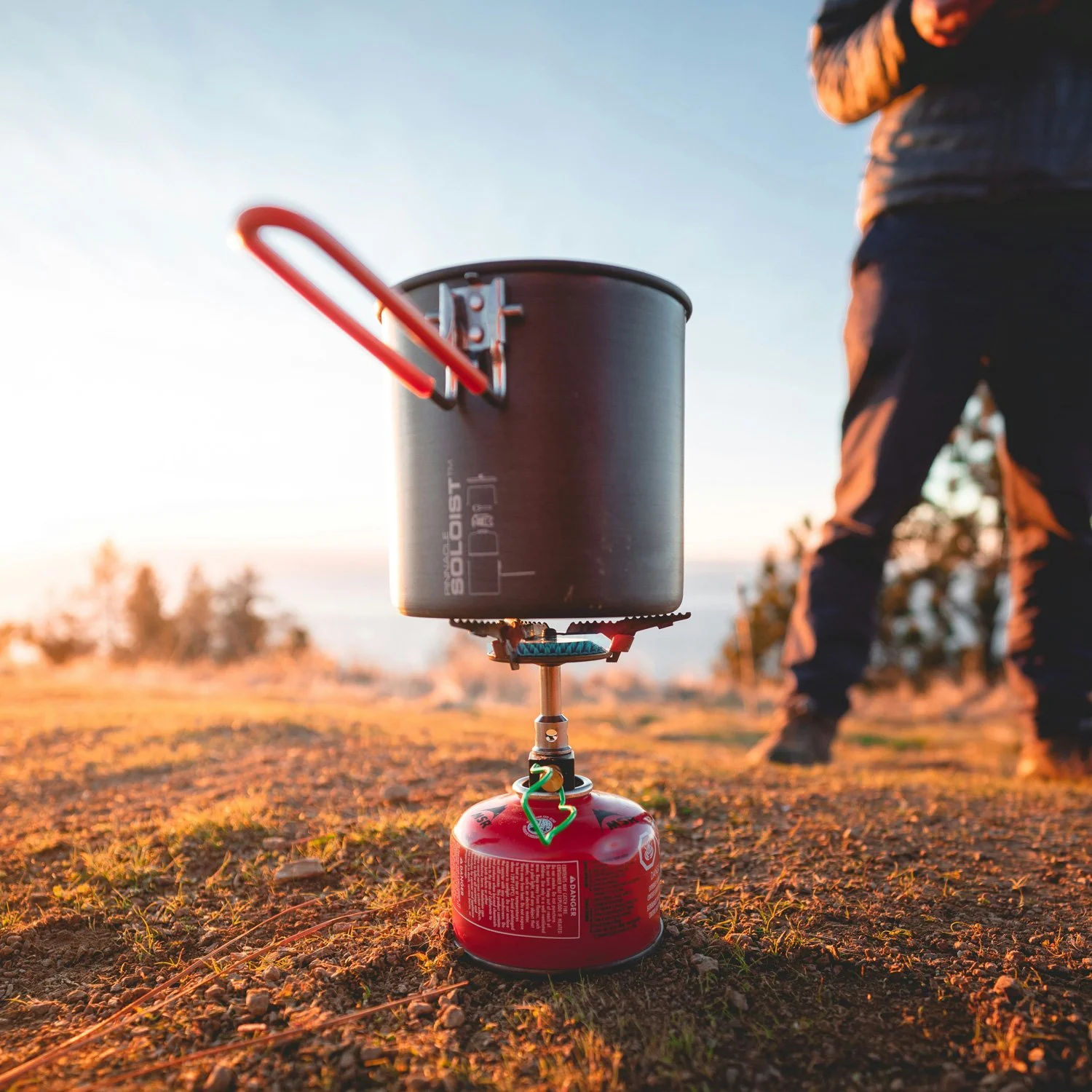 backpacking stove with red msr gas container.